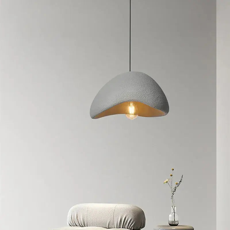 Gray textured half-moon pendant light with warm gold interior for stairs and living room in creamy style wabi decorbites