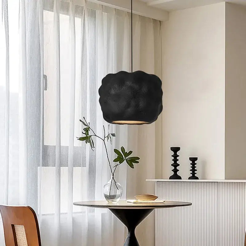 Black cloud-shaped pendant light with textured matte finish hanging above table for decorbites creamy style pendant lights