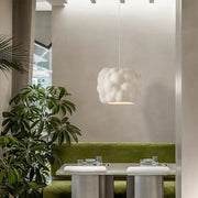 A creamy style pendant white cloud pendant light with textured surface hanging from bedroom ceiling from Decorbites