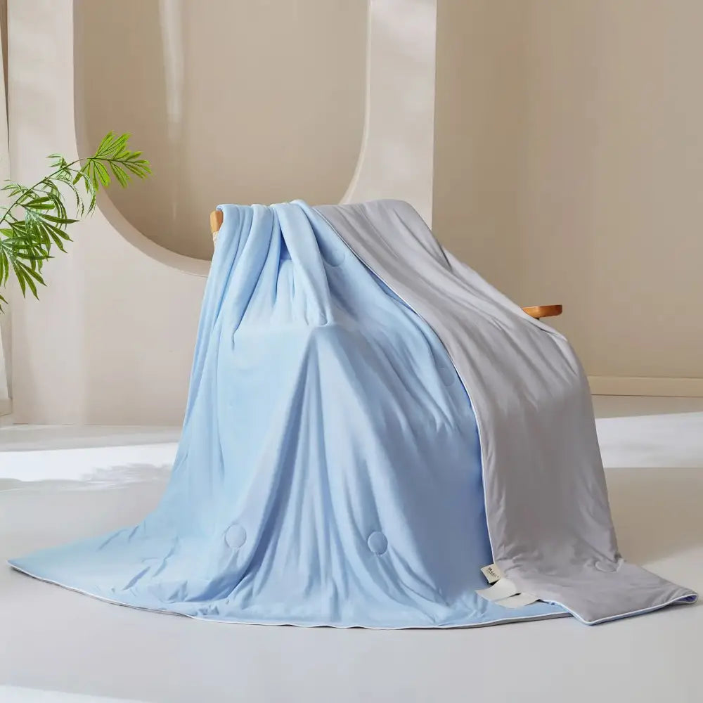 Light blue and gray two toned weighted blanket with plush fabric complementing decorbites ice cream silk quilt