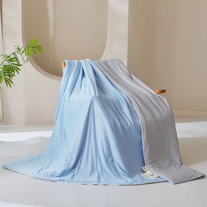 Light blue and gray two toned weighted blanket with plush fabric complementing decorbites ice cream silk quilt
