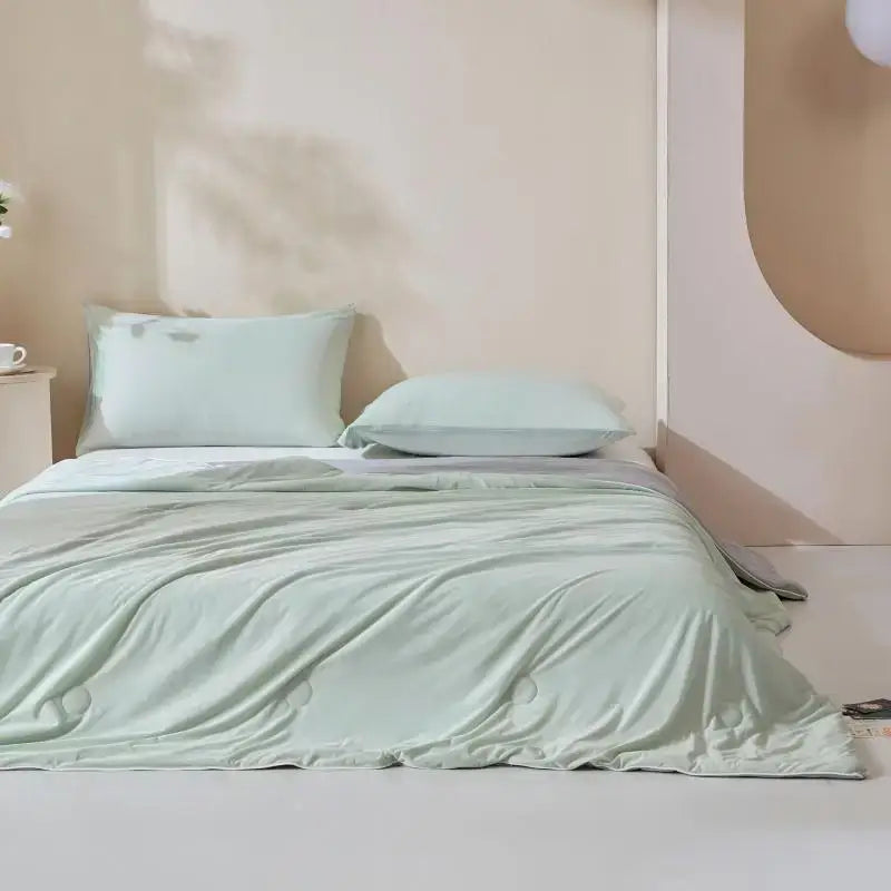 A soft mint green satin duvet cover with smooth texture and subtle sheen from the decorbites ice cream silk quilt collection