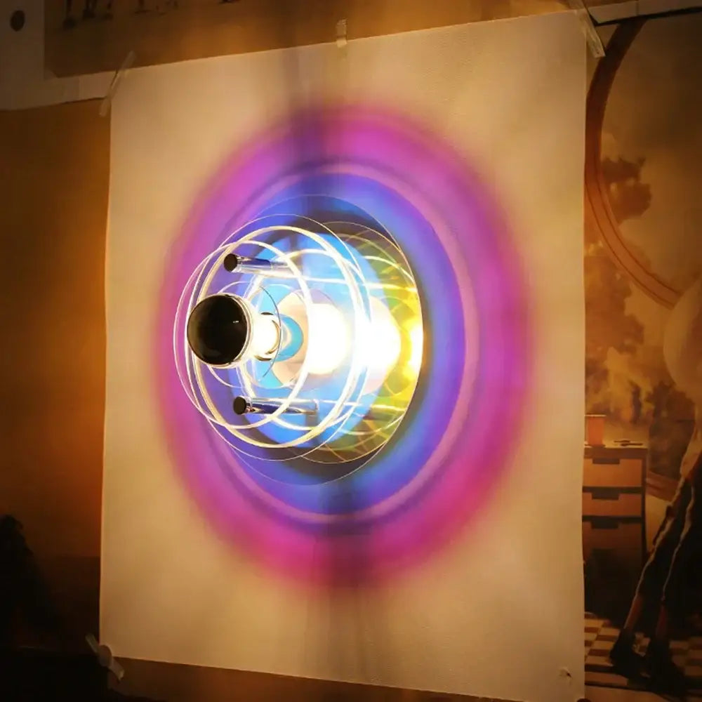 Creative acrylic wall lamp with glowing multi-colored purple blue and yellow concentric rings for bedroom decorbites decor