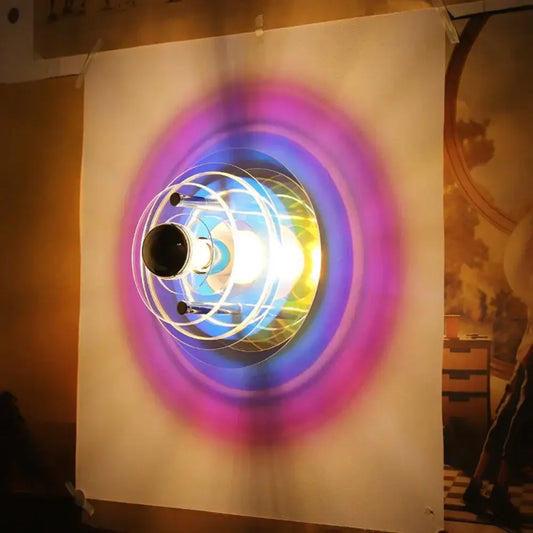 Creative acrylic wall lamp with glowing multi-colored purple blue and yellow concentric rings for bedroom decorbites decor
