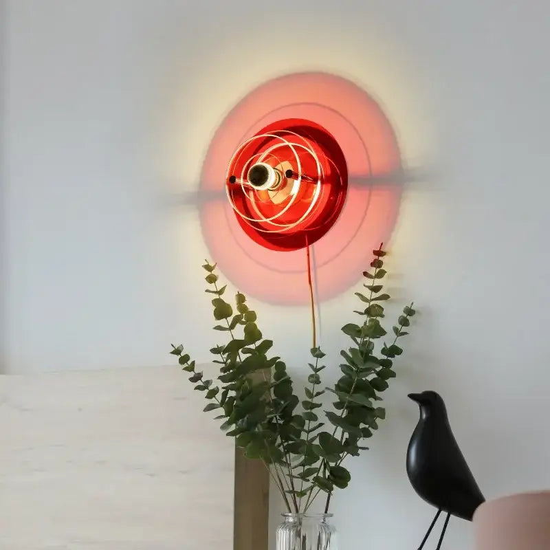 Vibrant red wall lamp with concentric wire rings and warm glow from decorbites creative acrylic wall collection