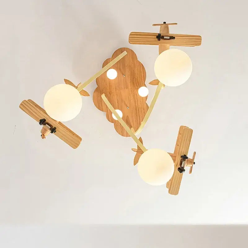 Creative airplane led wooden ceiling light fixture with three frosted glass bulbs and cloud-shaped wooden base for boys bedroom
