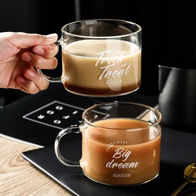 Clear glass mug with handle featuring trick or treat in white cursive and ranfang logo for decorbites creative alphabet glass juice use