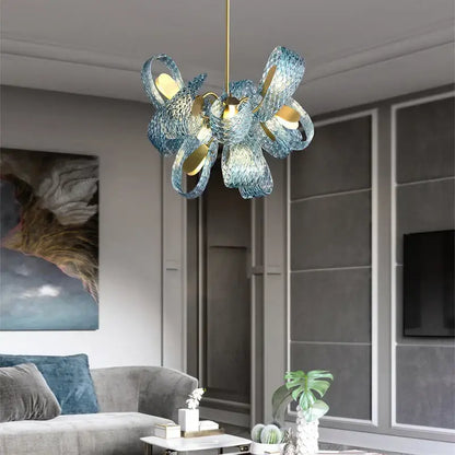 A modern blue glass pendant light with woven petal design and gold accents for luxury decorbites bedroom decor