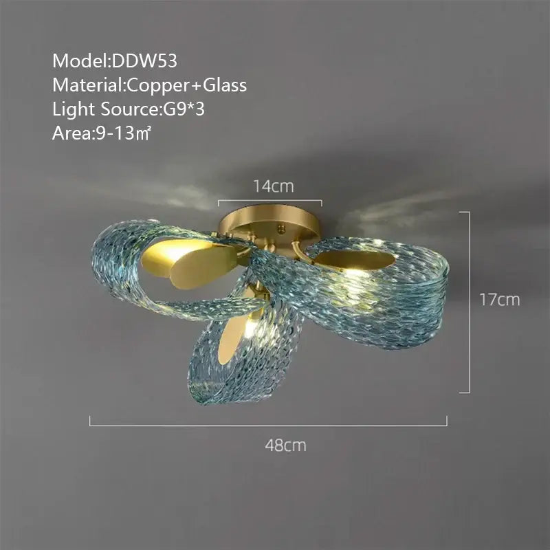 A modern pendant light with copper base and flowing blue glass luxury arms for bedroom decorbites blue glass style