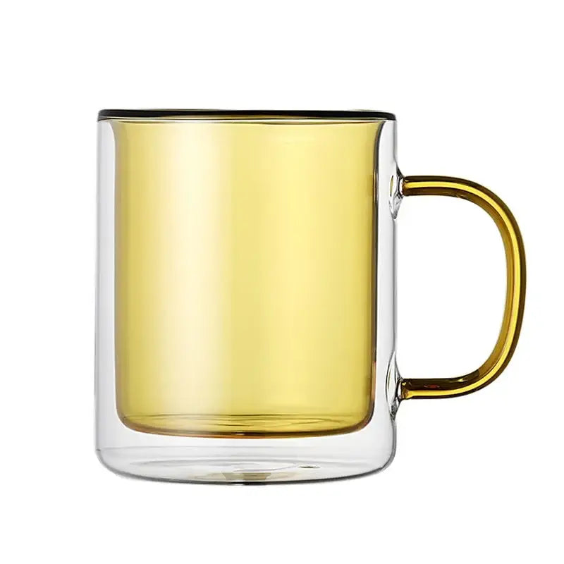 A double-walled glass whiskey wine glass tumbler with gold handle and rim filled with amber whiskey wine