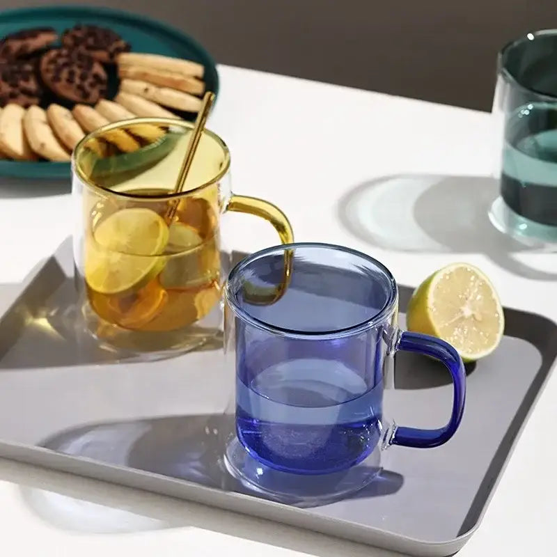 Creative whiskey wine glass tumbler set featuring transparent double-layer glass with gold and blue handles