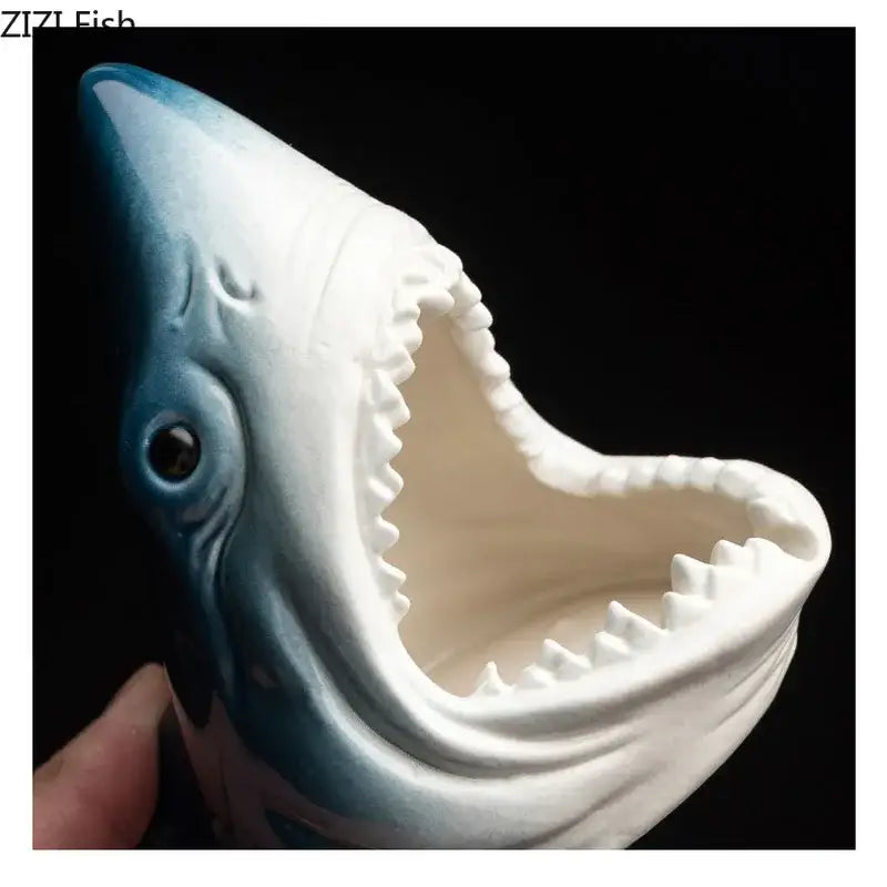 A ceramic blue and white shark storage ashtray with glossy finish and detailed teeth for creative shark decorbites decor