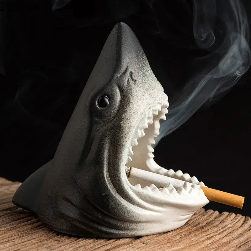 Gray ceramic shark storage ashtray with detailed teeth and black eye holding a cigarette for creative shark decorbites decor