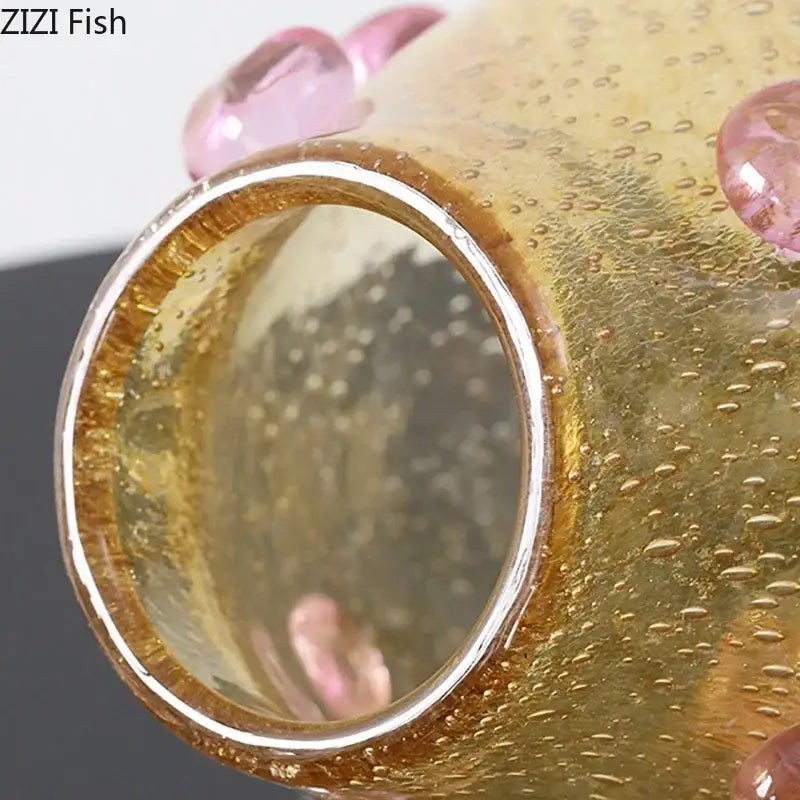 A translucent amber glass fish figurine with pink bubble embellishments and metallic rim for decorbites creative bubble decor