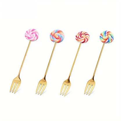 Four gold-colored candy donut dessert forks with colorful swirled lollipop handles in pink, rainbow, red-white, and multicolor patterns