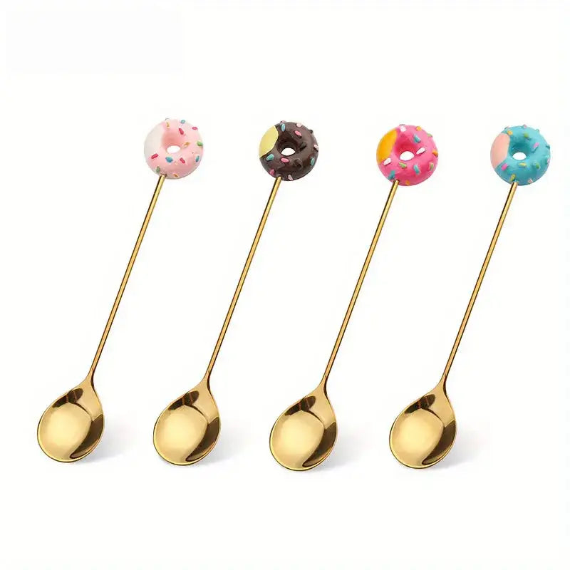 Four gold spoons with creative candy donut handles in pink chocolate orange pink and blue icing for dessert dining