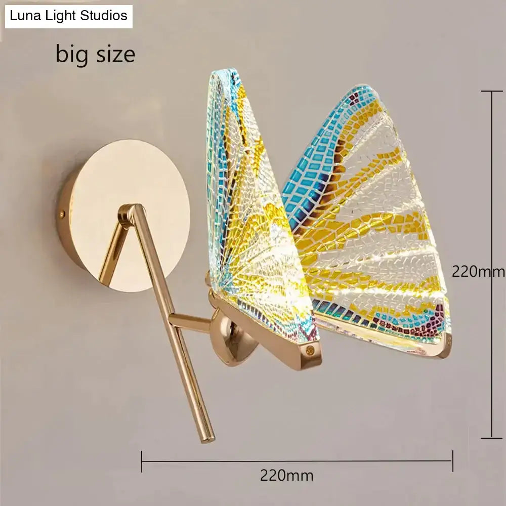Creative colorful butterfly led wall lamp featuring mosaic glass wings in blue yellow and white on a gold frame