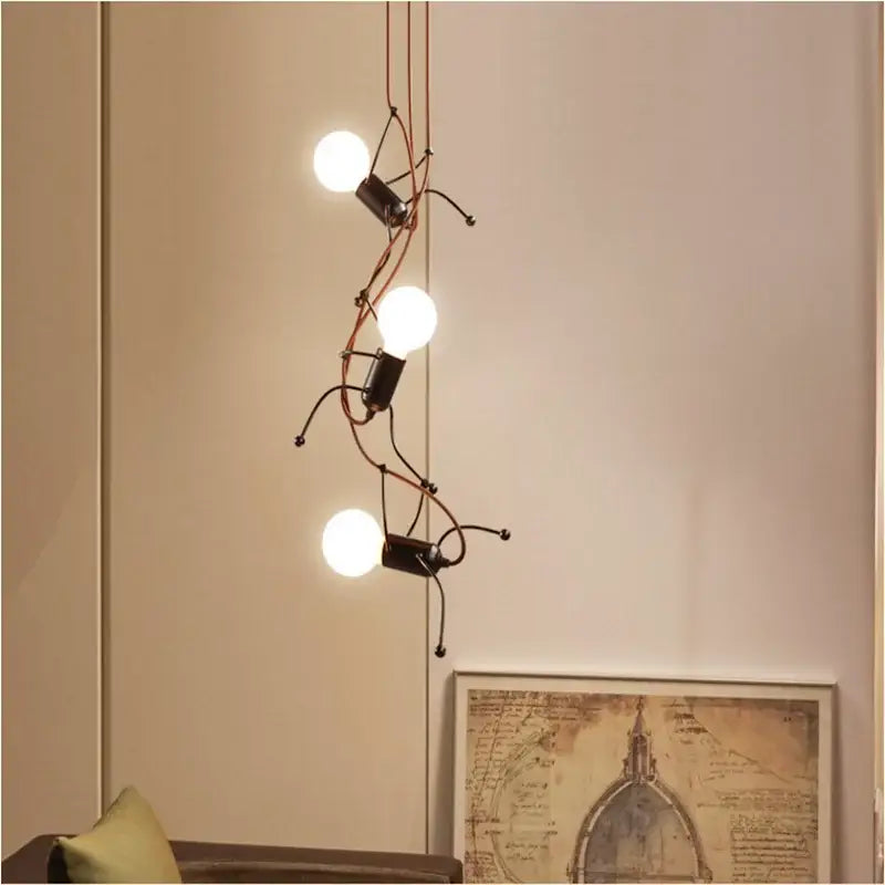 Creative copper iron man chandelier with three glowing bulbs on black metal figures and copper wires for bedroom decorbites iron man