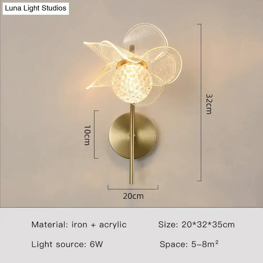 Creative floral decorative gold led wall lamp featuring spherical faceted crystal globe and sheer mesh petals for bedroom
