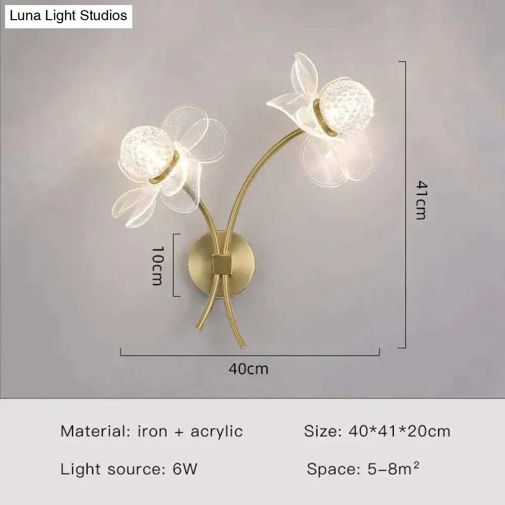 Gold-toned creative floral decorative led wall sconce with two translucent flower-shaped iron and acrylic fixtures for bedroom