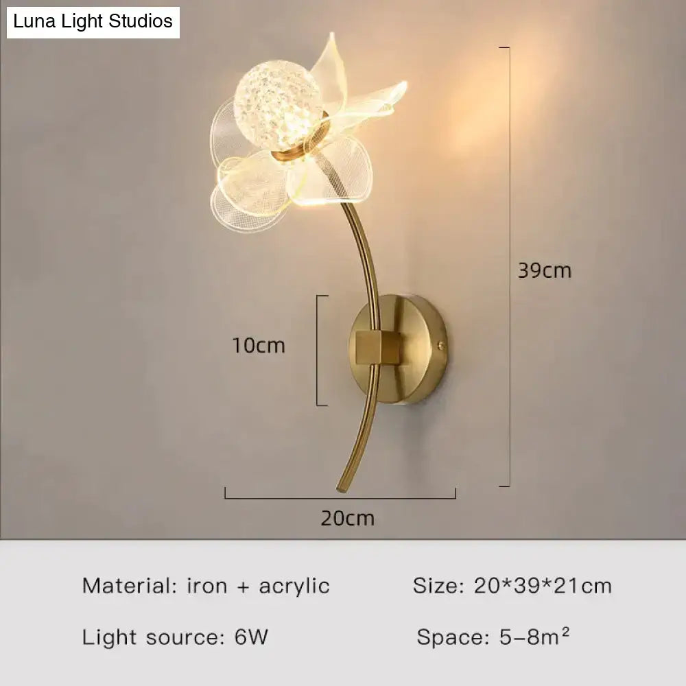 Creative floral decorative gold led wall lamp with clear acrylic petals and textured crystal center for bedroom use