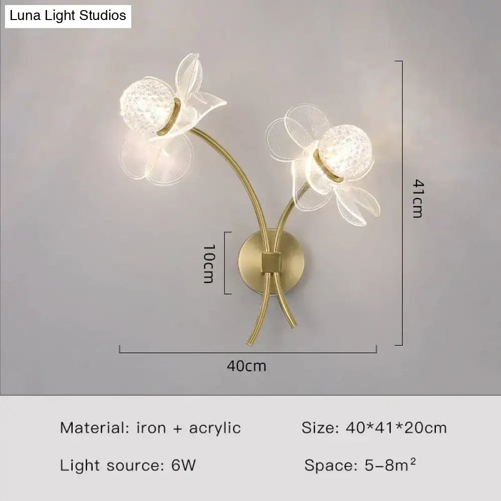 Creative floral decorative gold led wall lamp with two translucent acrylic flower heads and textured crystal centers