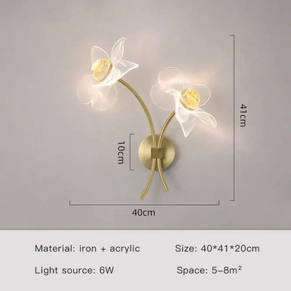 Creative floral decorative gold led wall sconce with two translucent acrylic flowers and warm amber centers for bedroom