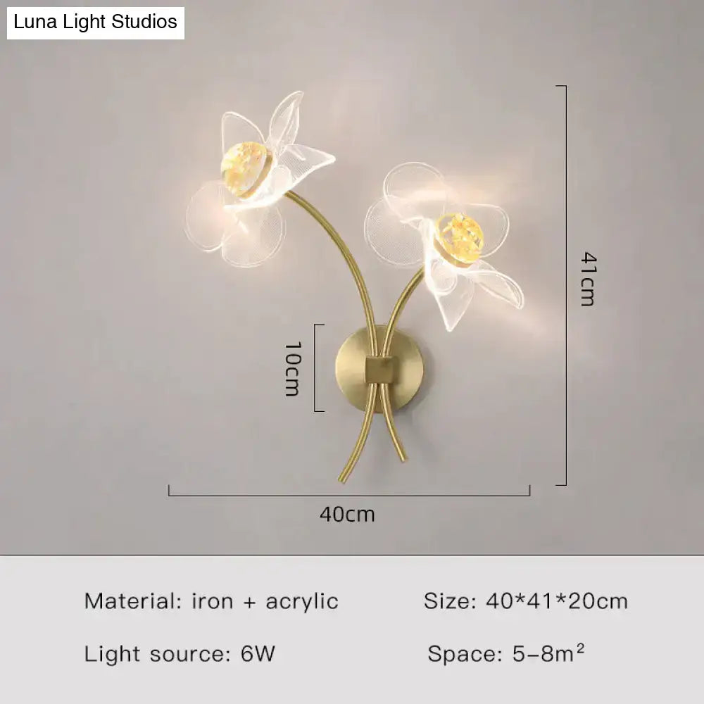 Creative floral decorative gold led wall lamp with two translucent white acrylic flowers and warm yellow crystal centers