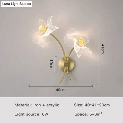 Creative floral decorative gold led wall lamp with two translucent white acrylic flowers and warm yellow crystal centers