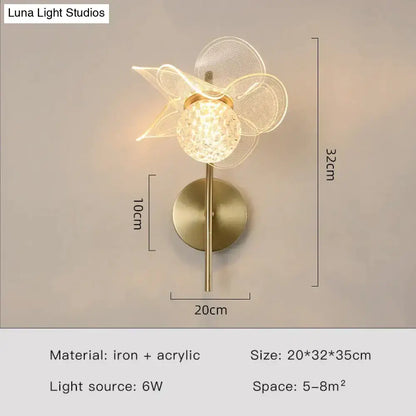 Creative floral decorative gold led wall lamp featuring a faceted crystal globe and sheer mesh petals for bedroom use