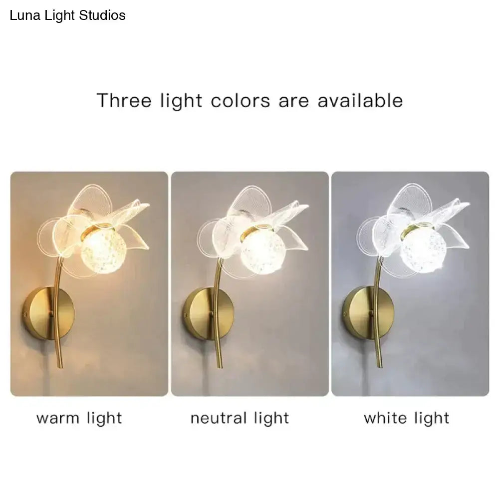 Creative floral decorative translucent flower-shaped wall sconce with brass-finished stem and decorative gold led light