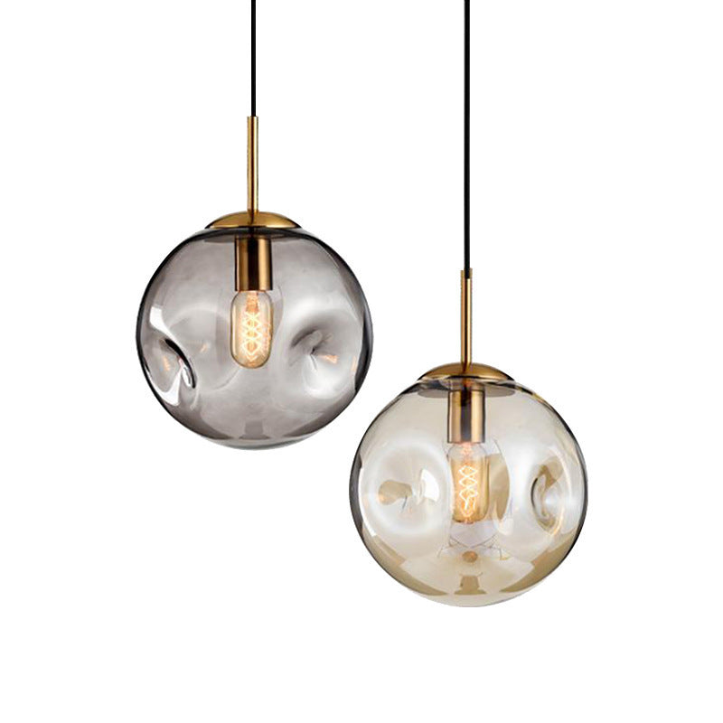 Modern creative glass chandelier with smoky gray smoked glass globe, brass accents, black cord, and led lamp for restaurants