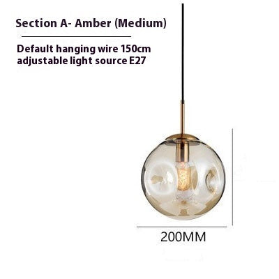 Amber glass globe pendant light with gold accents and black hanging wire, 20cm in diameter.