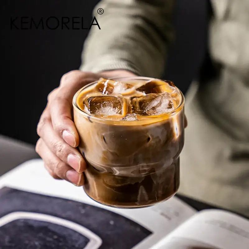 Creative glass coffee smoothie cup made of transparent glass with ice and dark cold brew coffee by decorbites