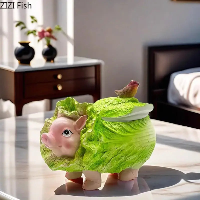 A charming pink decorbites cabbage pig ashtray wrapped in green cabbage leaves with a bird on its lid for living room use