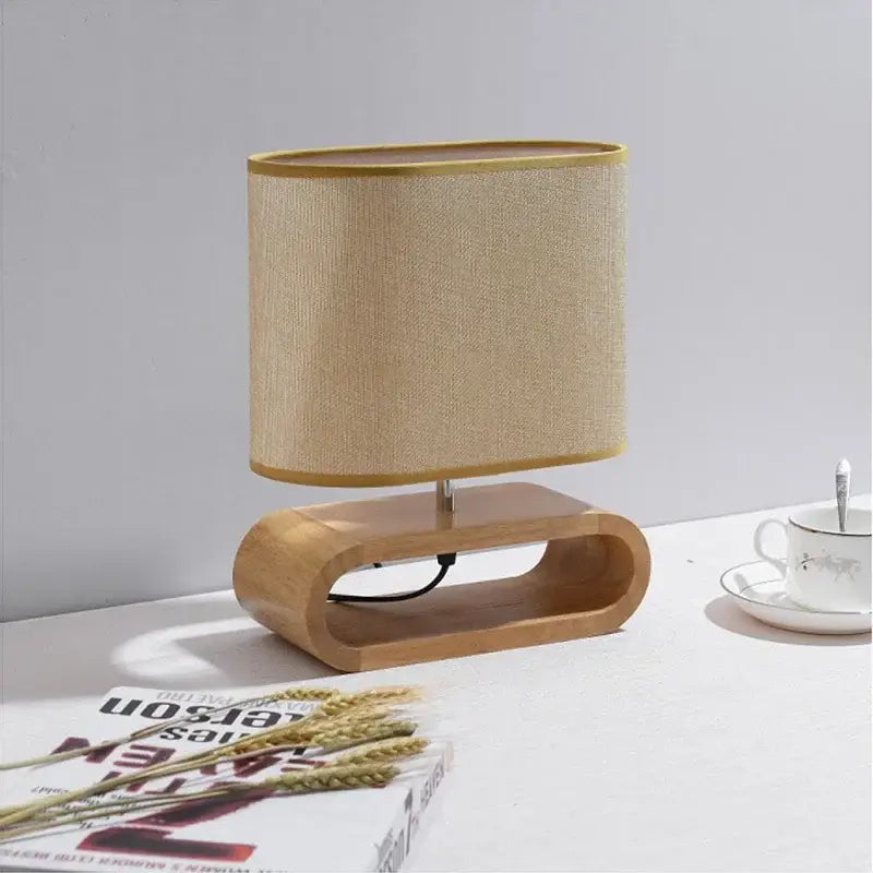 Beige linen lampshade with gold trim on a creative nordic wooden table lamp for bedroom decorbites creative nordic