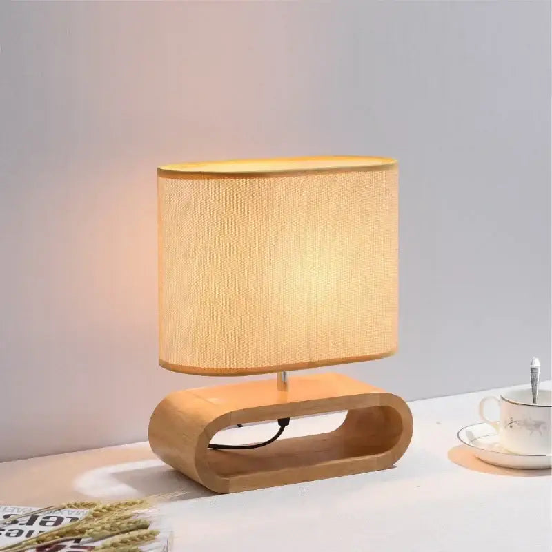 Warm-toned decorbites creative nordic wooden table lamp with beige linen shade and curved light wood base for bedroom decor
