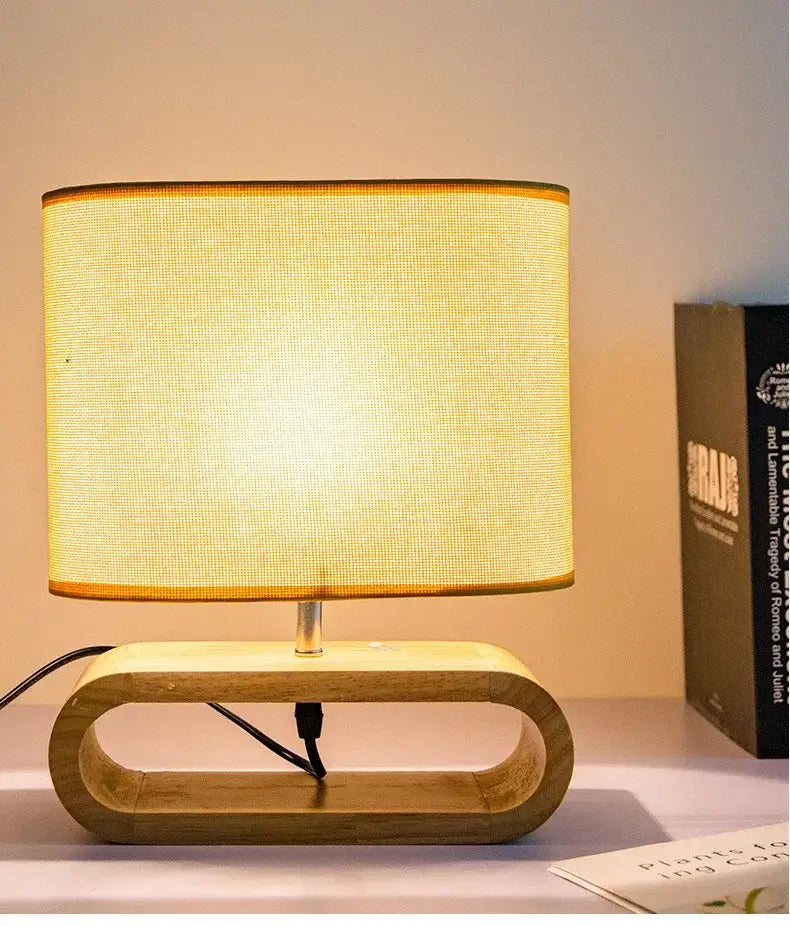 Warm-toned beige linen creative nordic wooden table lamp with textured fabric shade and oval cutout wooden base for bedroom decorbites creative nordic