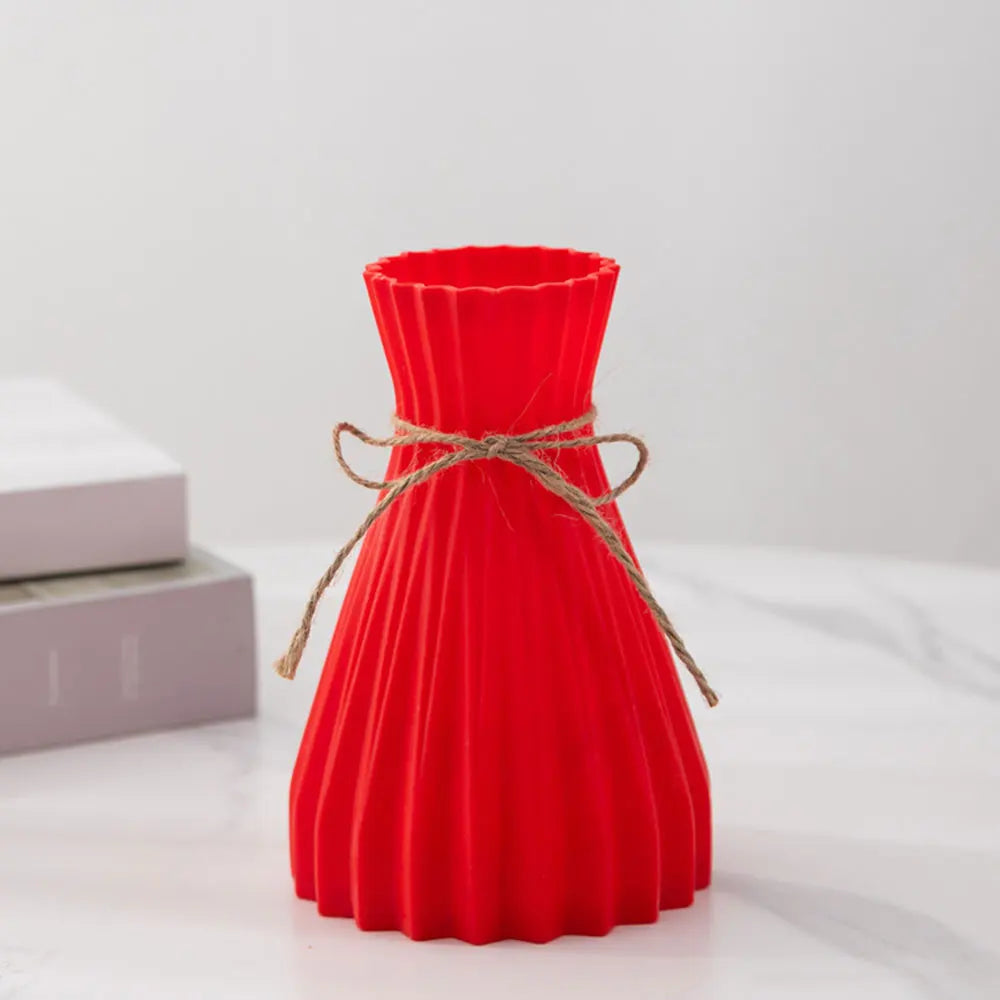 Vibrant red pleated silicone flower bottle with rustic twine bow in a modern dry flower bottle design
