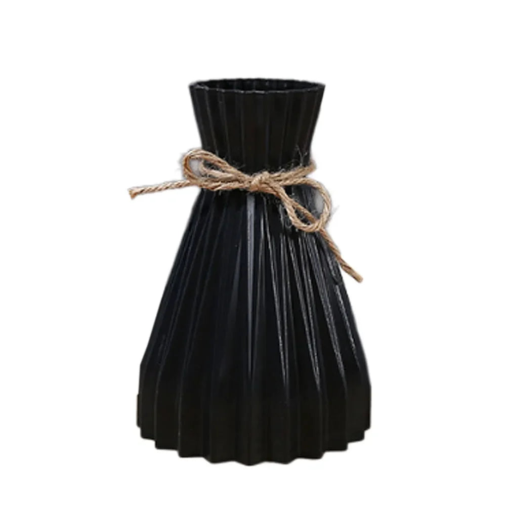 Black pleated ceramic flower bottle with rustic twine bow, a modern dry flower bottle type with origami-inspired design