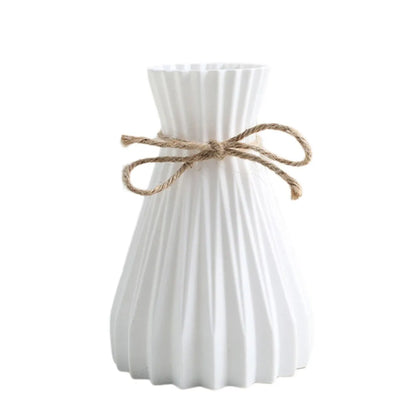 White ceramic flower bottle type vase with vertical ridges and natural twine bow for dry flower bottle display