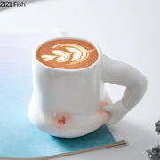 White ceramic creative pinch belly ceramic mug with sculpted hand handle and delicate leaf latte art on top