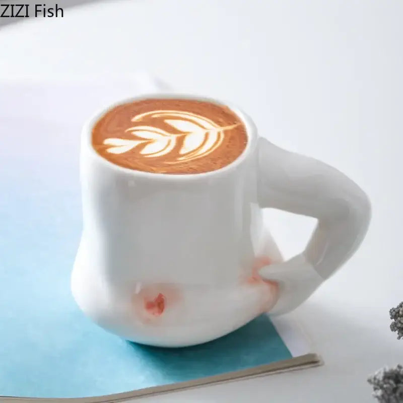 White ceramic creative pinch belly ceramic mug with sculpted hand handle and delicate leaf latte art on top
