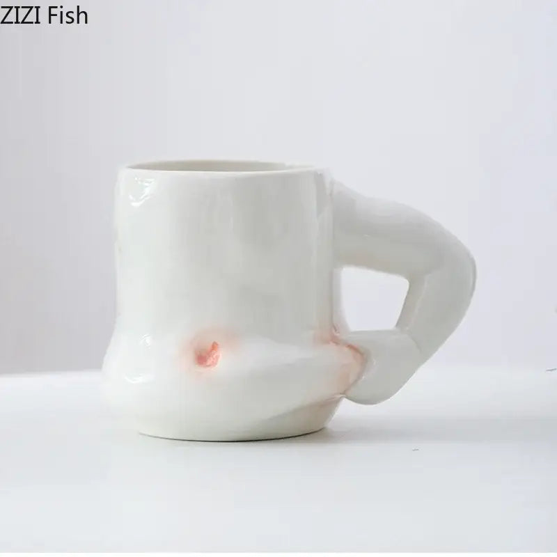 White ceramic creative pinch belly cup with sculpted hand handle and subtle pinkish orange glaze accents for dining room use
