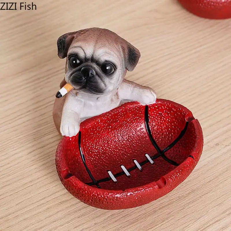 A tan and white basketball puppy ashtray figurine holding a cigarette on a red football-shaped decorbites ashtray