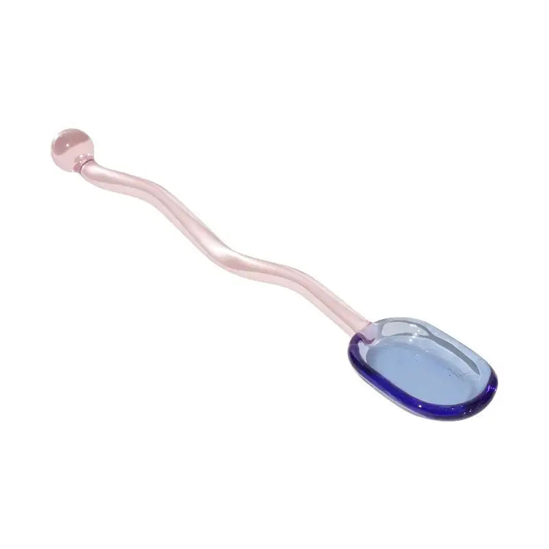 Translucent pink glass spoon with wavy handle and blue-tinted bowl from creative purple and green glass spoon dessert set for ice cream
