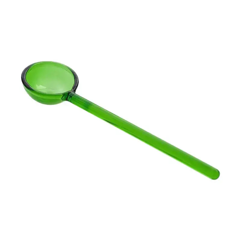 Translucent green plastic ladle with smooth rounded bowl and long handle from creative purple and green glass spoon dessert set