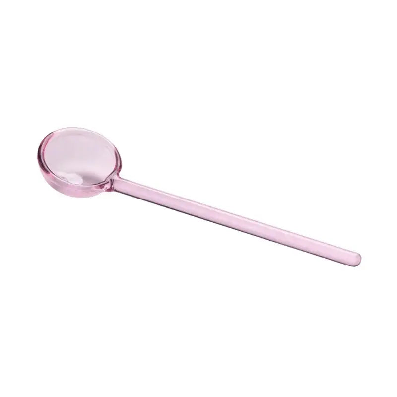 A translucent pink glass spoon with a smooth bowl from creative purple and green glass spoon dessert set for ice cream