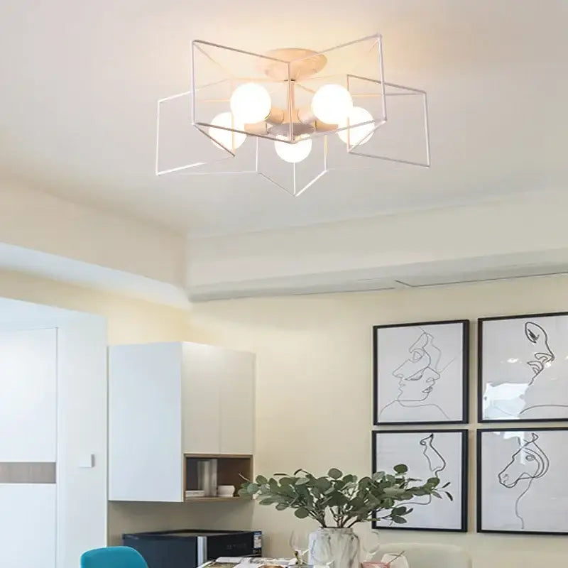 Modern geometric ceiling chandelier with five frosted glass bulbs in brushed gold minimalist metal frame decorbites creative star led