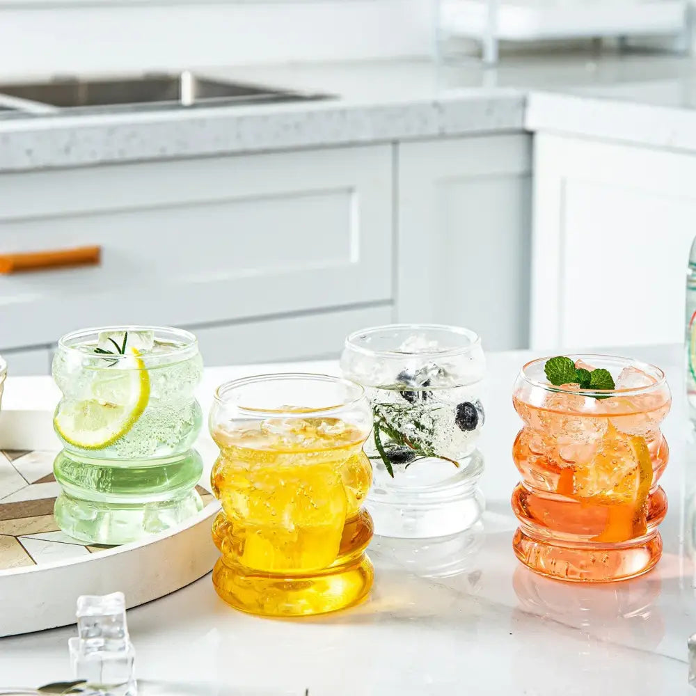 Three colorful ribbed glass tumblers with ice and garnishes from decorbites creative styling glass drinkware collection